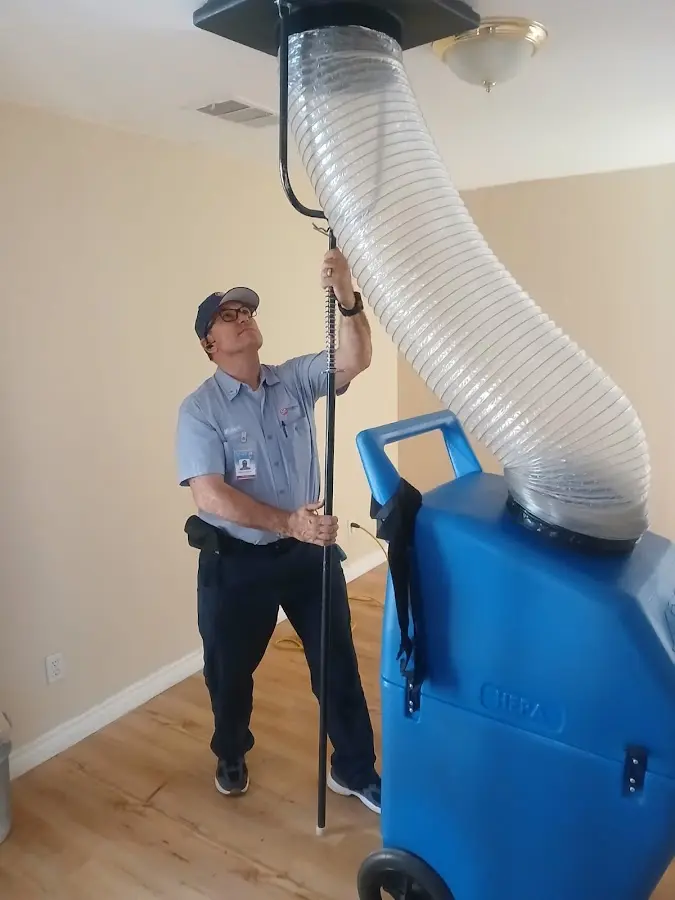 Furnace Tune-Up technician using HEPA equipment in Pace
